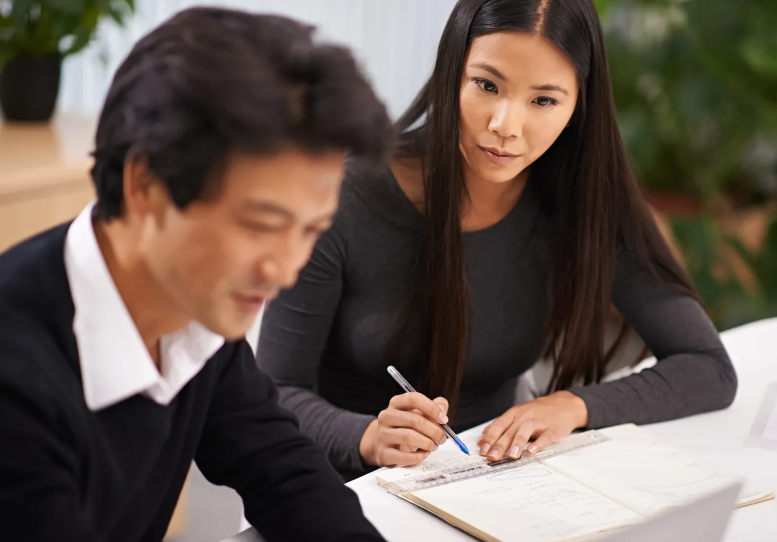 A teacher working one to one with a senior student over a notebook