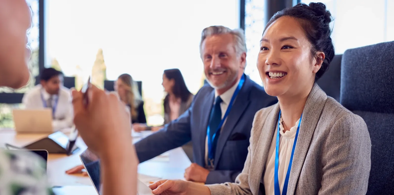 Colleagues talking and listening around a meeting table