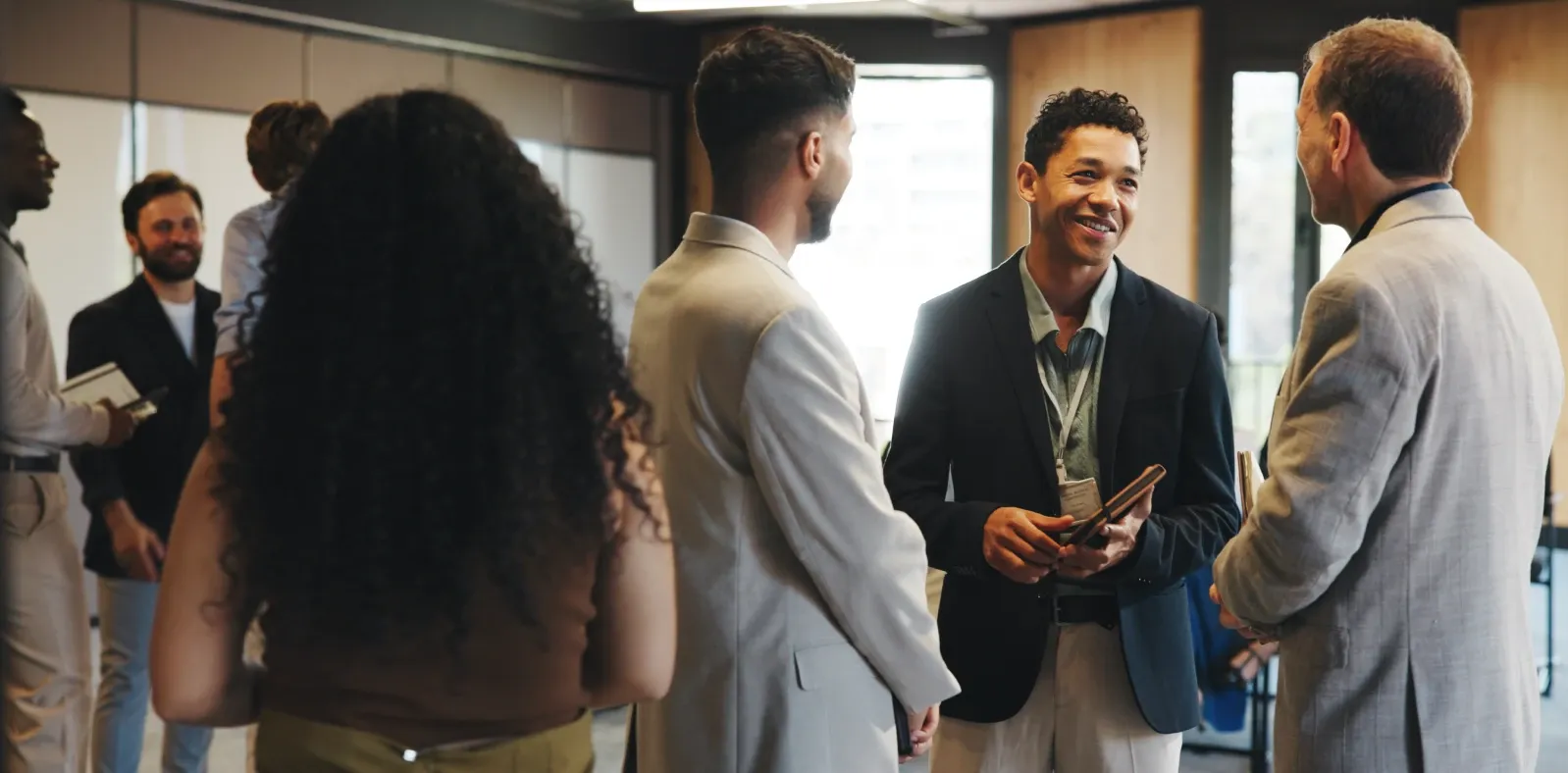 Professionals standing and talking in small groups at a networking event