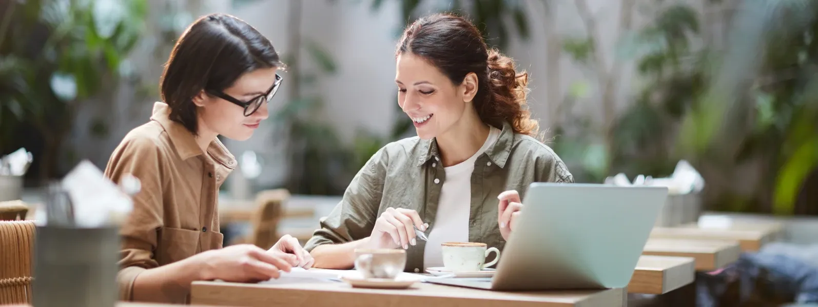 A teacher and student working through a lesson together at a café table