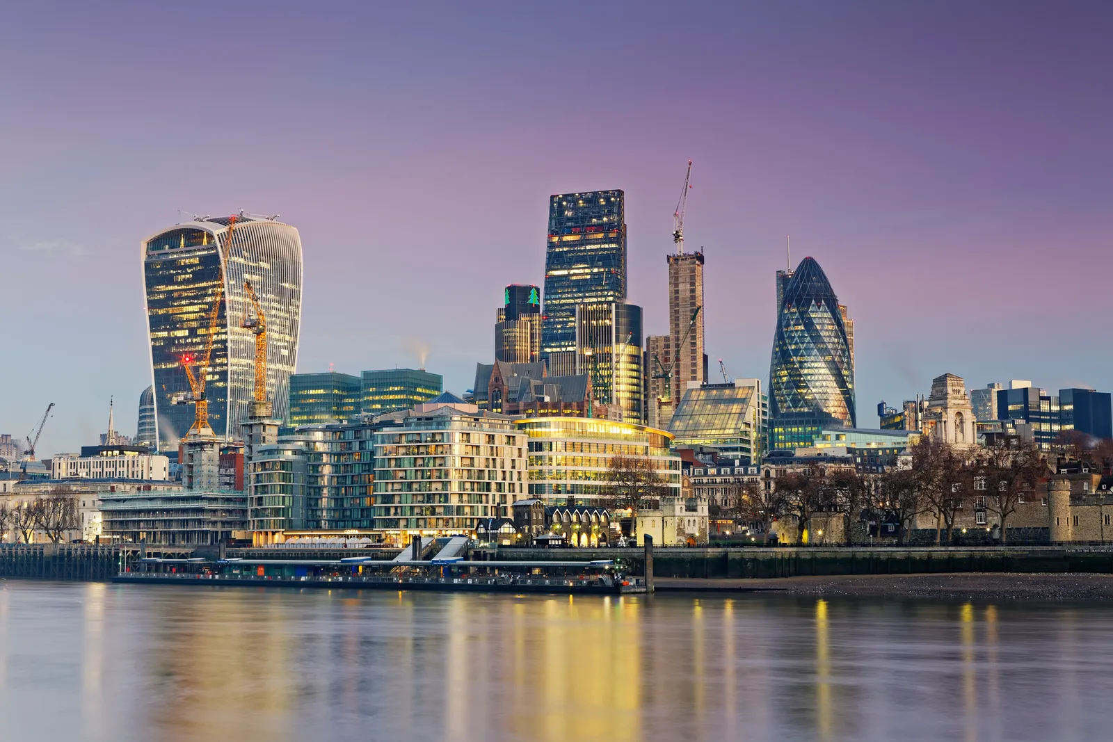 The City of London skyline at dusk, seen across the Thames