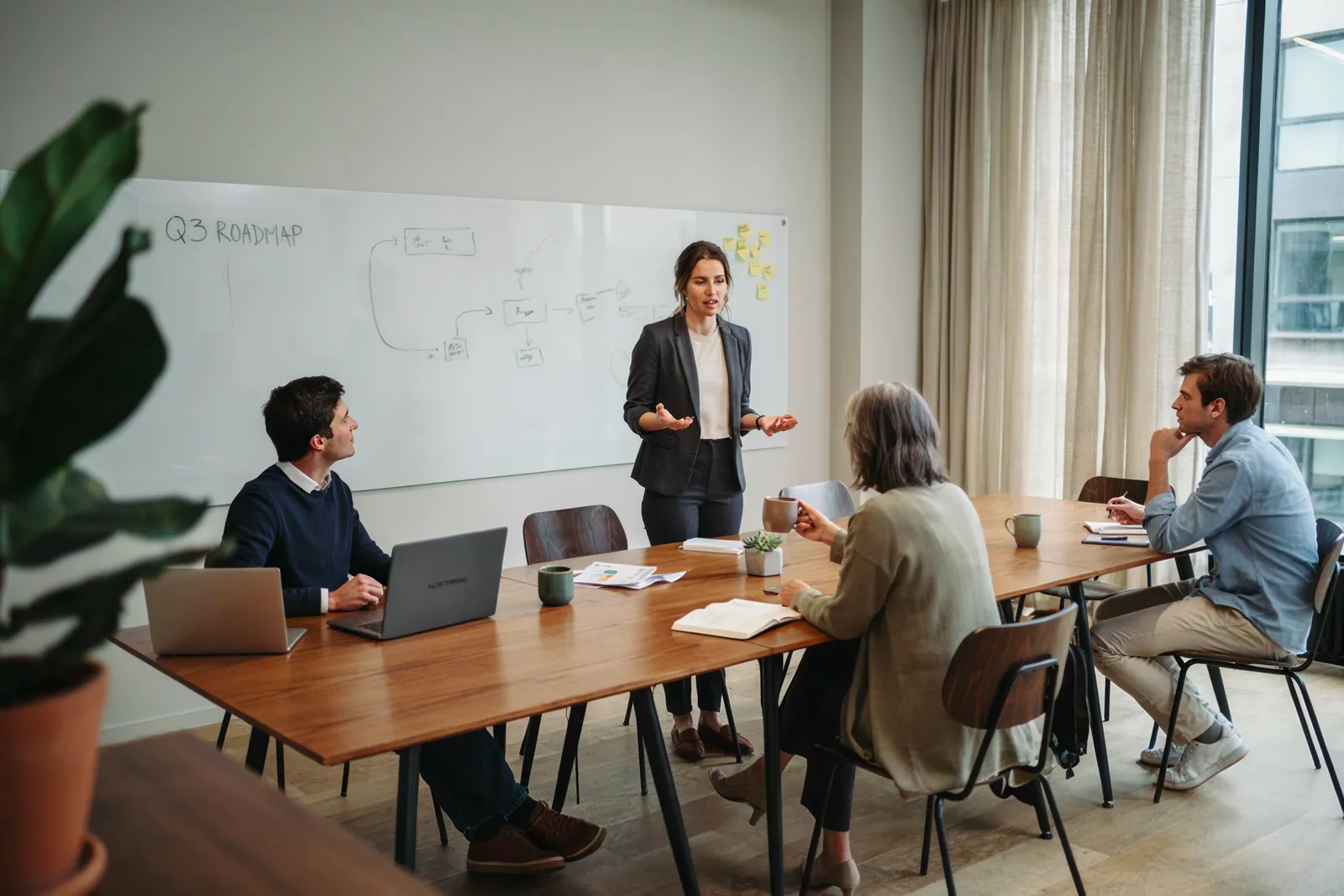 A speaker presenting to colleagues in a meeting room